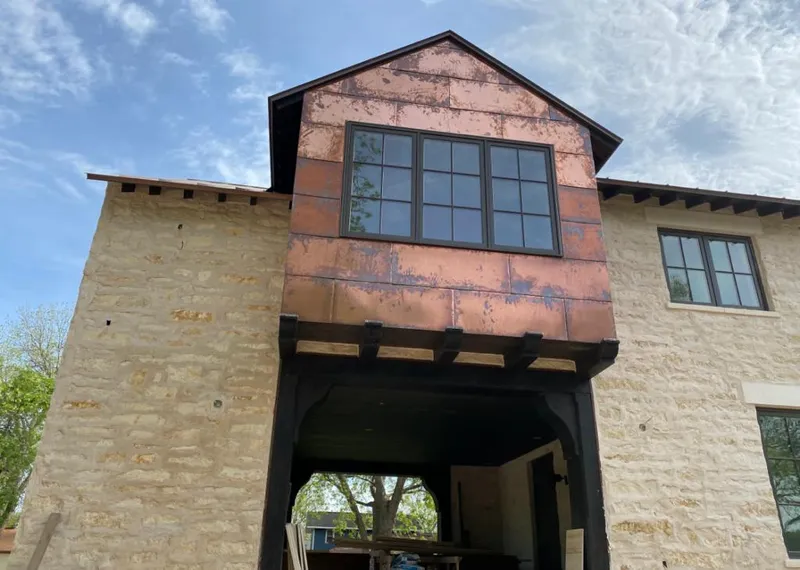 Copper metal panel facade on a stone building for Metal Roof Coating in Colby